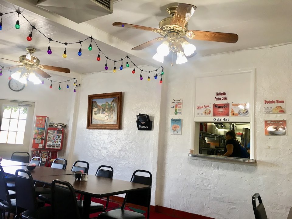 Casual interior with table service and warm lighting.